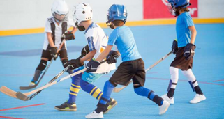 4 kids playing ball hockey